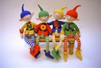 knitted toys of 4 festive imps spelling out 'Noel' on their tops