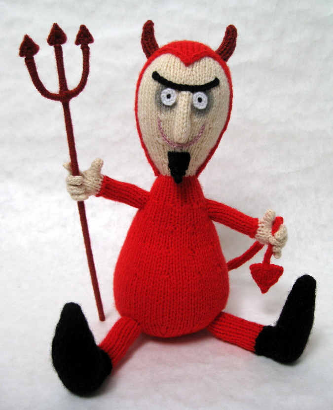 knitted toy of a devil with a pitchfork