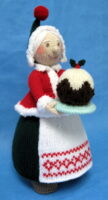 knitted toy of Mrs Santa Claus with a large Christmas pudding