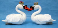 knitted toys of 2 swans nestling beaks together