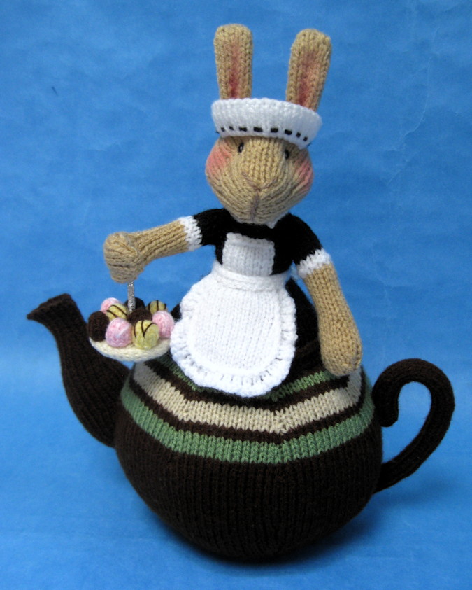 knitted toy of a bunny waitress on a tea pot