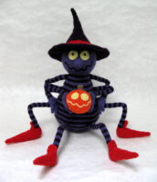 knitted toy of a spider in a witch's hat