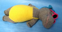 knitted toy of a hippo sunbathing in a bathing costume