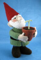 knitted toy of a gnome with a plant in a flower pot