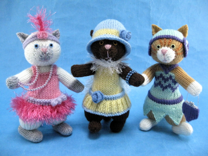 knitted toys of cats dressed as 1920's flappers