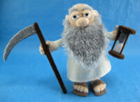 knitted toy of Old father time with a sickle and an hour glass