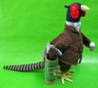 knitted toy of a pheasant dressed for golf