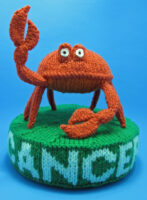 Knitted toy of a crab