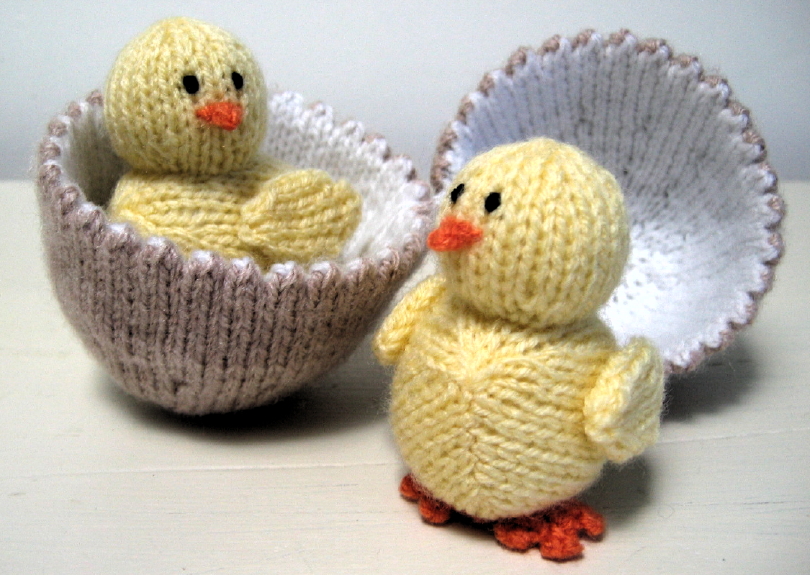 Knitted toys of 2 small chicks in their eggs