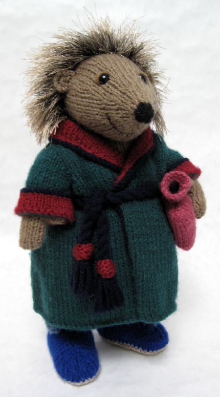 knitted toy of a hedgehog in a dressing gown ready for bed