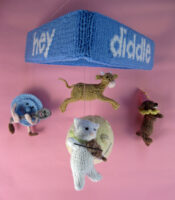 knitted mobile for a baby with characters from the nursery rhyme Hey diddle diddle