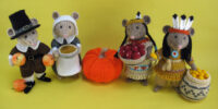 a group of mice knitted toys dressed as a pilgrim father and wife and Native Americans