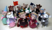 a group of mice knitted toys dressed in medieval clothes