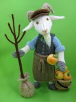 knitted toy of a goat dressed as a gardener ready to plant a tree