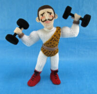 knitted toy of a strong man with weights and a leopard skin leotard