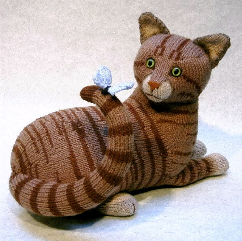 knitted toy of a tabby cat with a butterfly on it's tail