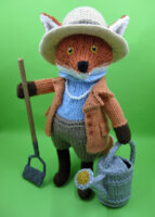 knitted toy of a fox dressed as a gardener